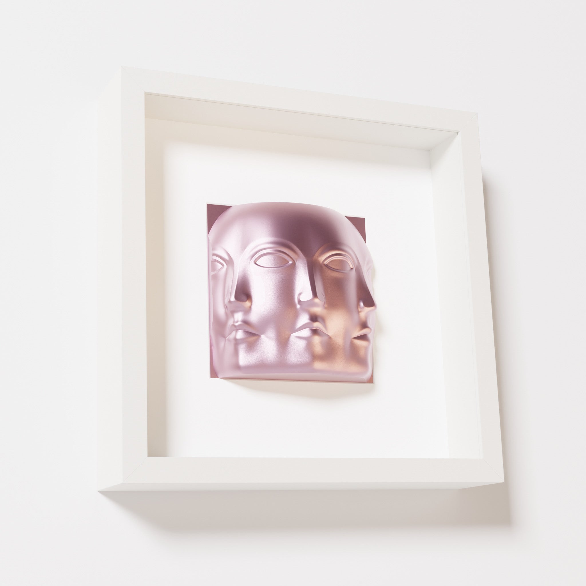 A close-up of a white shadowbox frame containing a metallic rose sculpture of 'Dora,' featuring three interconnected faces merging at the edges, creating a surreal and multi-dimensional effect.