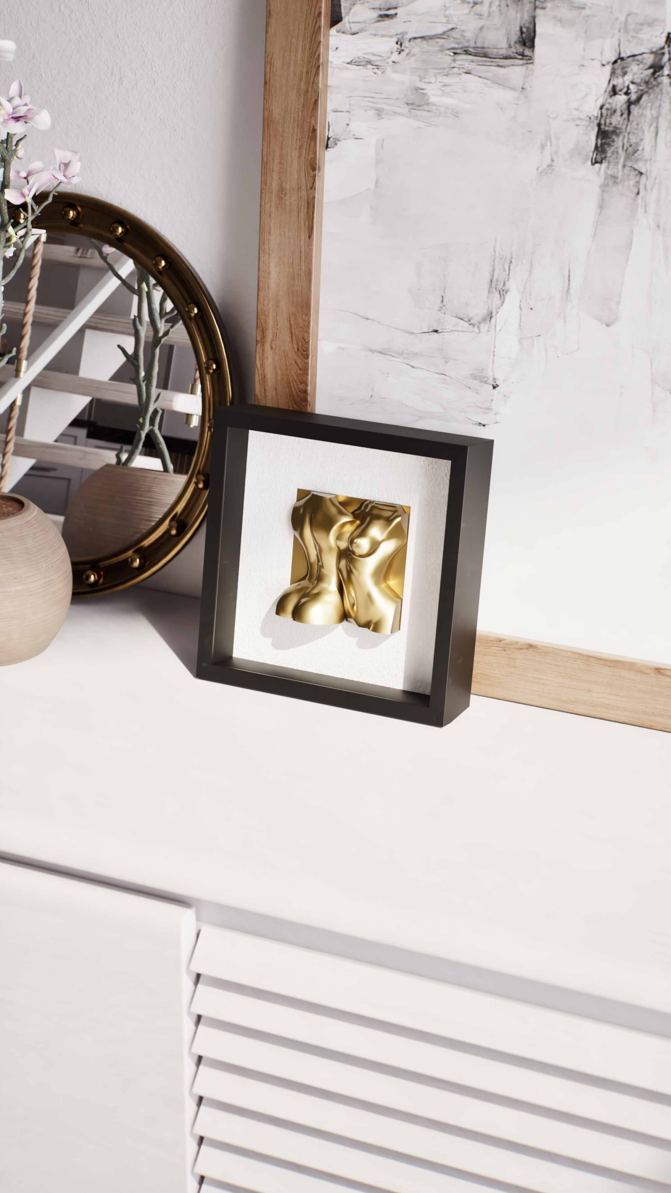 A detailed close-up of a modern white sideboard, showcasing a black shadowbox frame containing a gold sculpture of human torsos. The frame is placed next to a round decorative mirror with a gold rim and a minimalist vase with pink flowering branches, creating an elegant and artistic vignette.