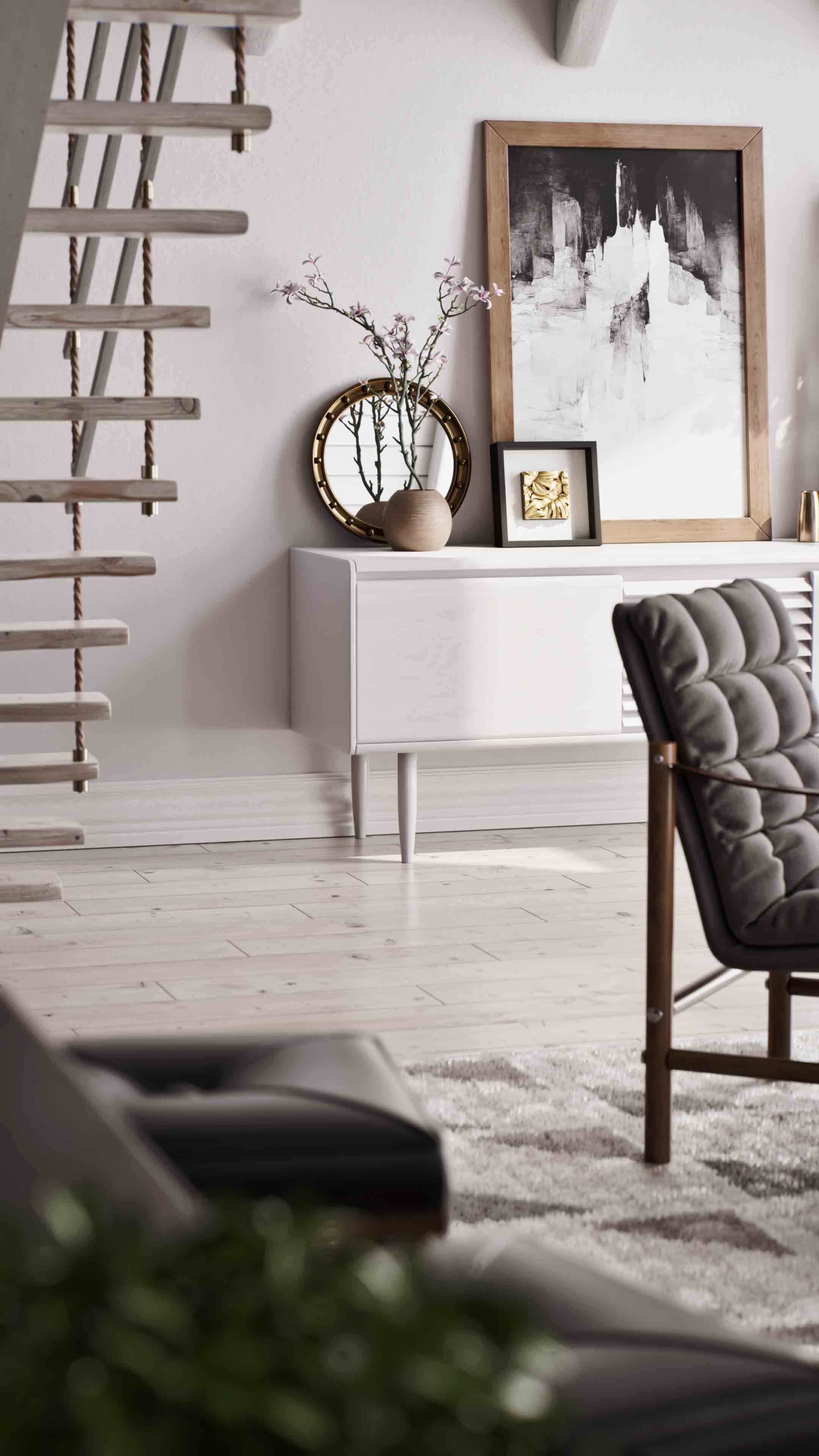 A serene living space featuring a white sideboard adorned with minimalist decor, including a round mirror, a ceramic vase with branches, and a black shadowbox frame showcasing a gold artwork. The arrangement is complemented by a wooden-framed abstract painting and modern staircase, exuding a harmonious blend of elegance and simplicity.