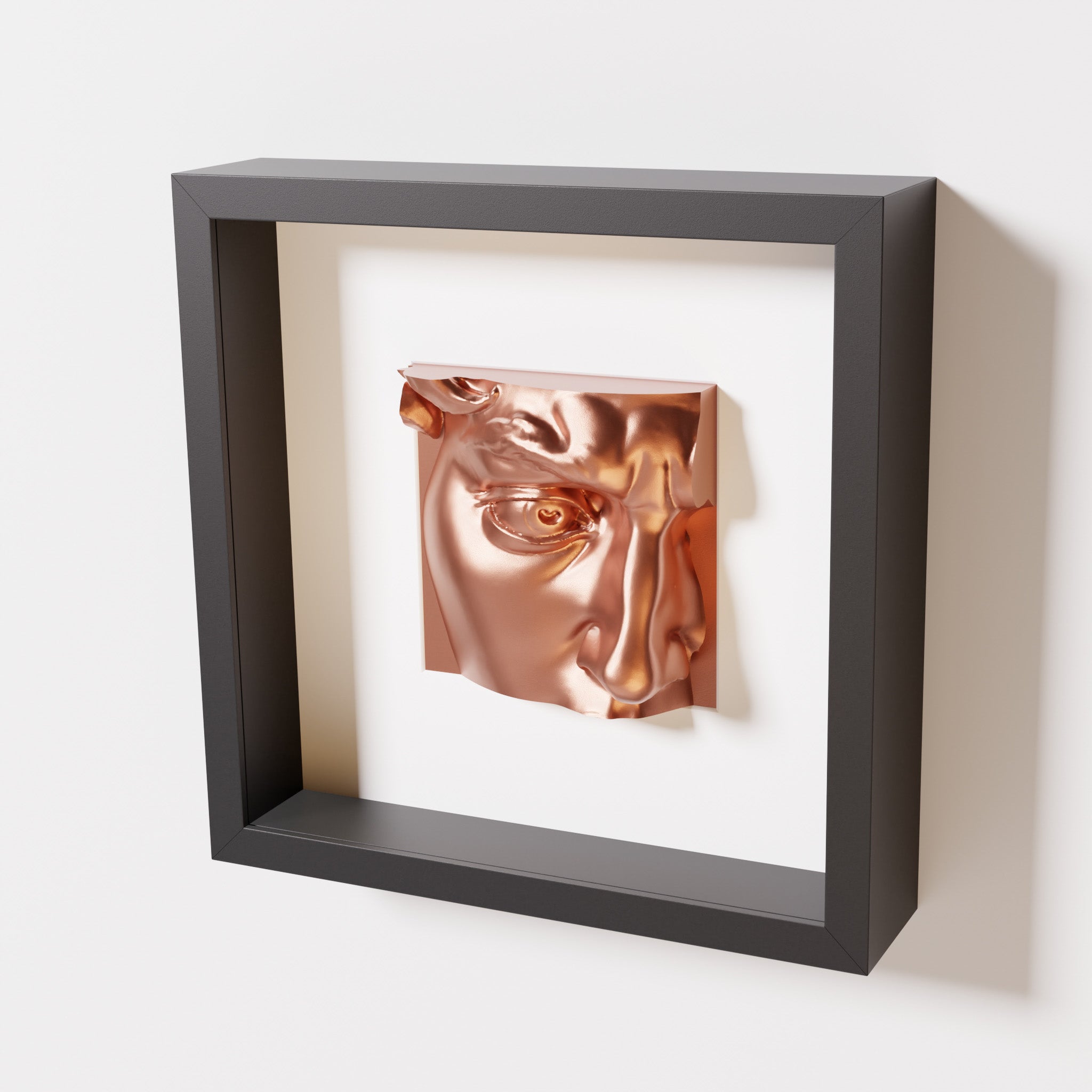 A close-up of a black shadowbox frame containing a chrome copper sculpture of 'David's Eye,' highlighting the intricate details of the eye, brow, and surrounding textures.