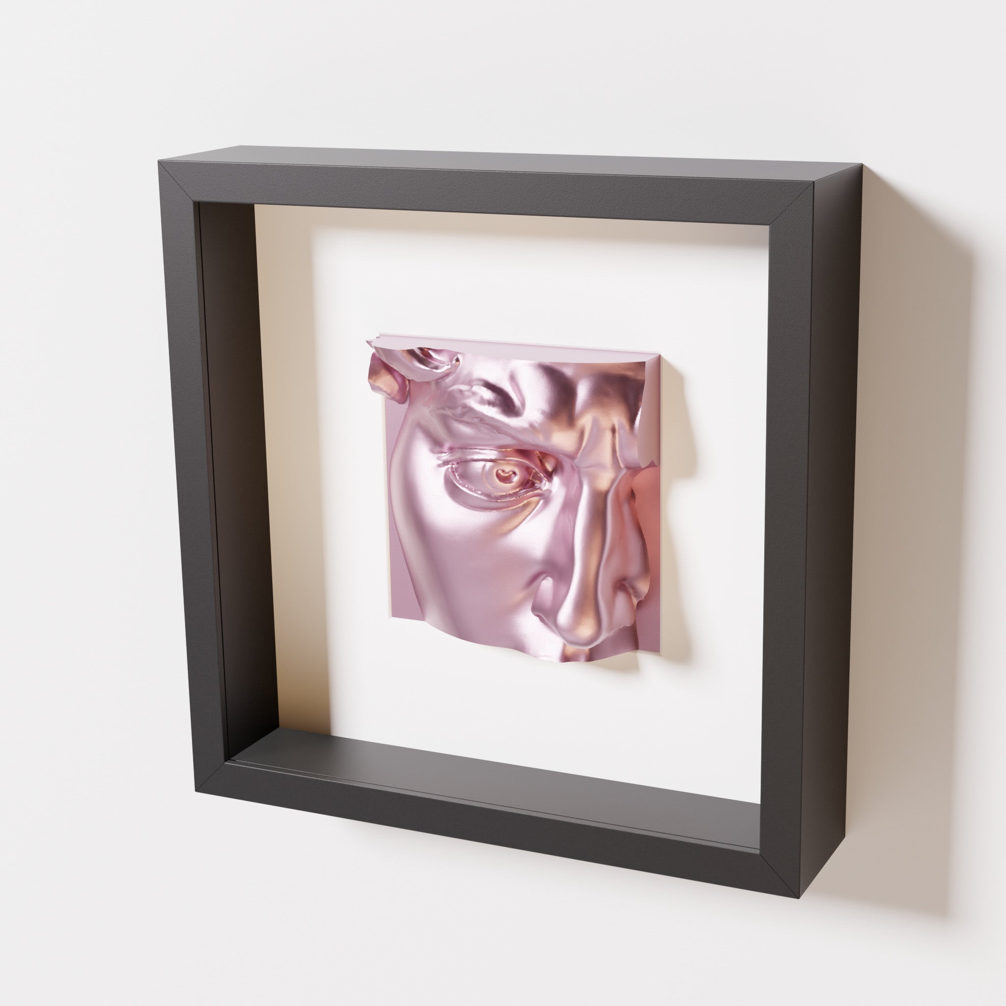 A close-up of a black shadowbox frame containing a metallic rose sculpture of 'David's Eye,' highlighting the intricate details of the eye, brow, and surrounding textures.