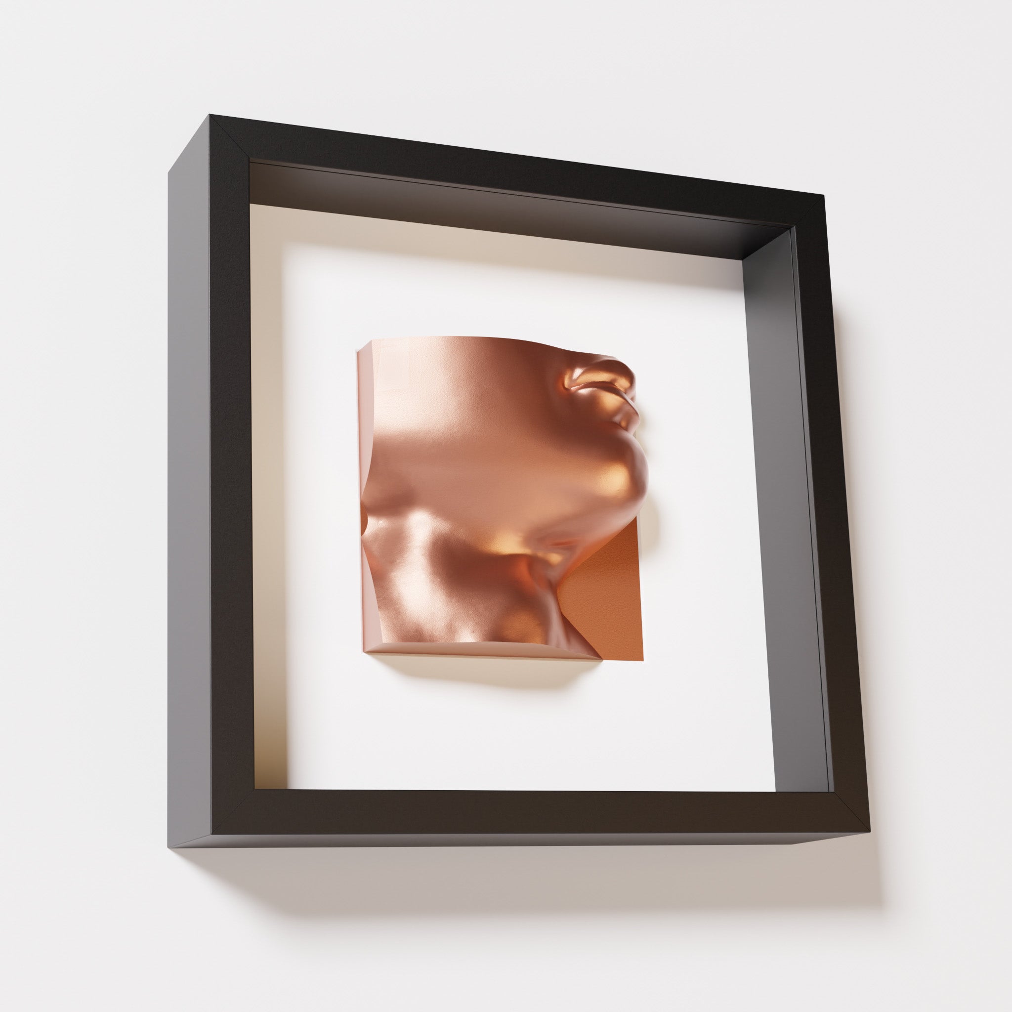 A close-up of a black shadowbox frame containing a chrome copper sculpture of 'David's Lip,' highlighting the detailed lips, chin, and reflective copper finish inspired by Michelangelo's David.