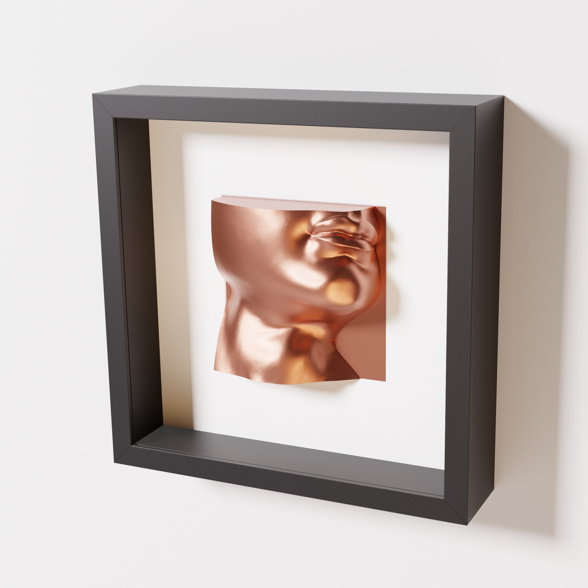 A close-up of a black shadowbox frame containing a chrome copper sculpture of 'David's Lip,' highlighting the detailed lips, chin, and reflective copper finish inspired by Michelangelo's David.