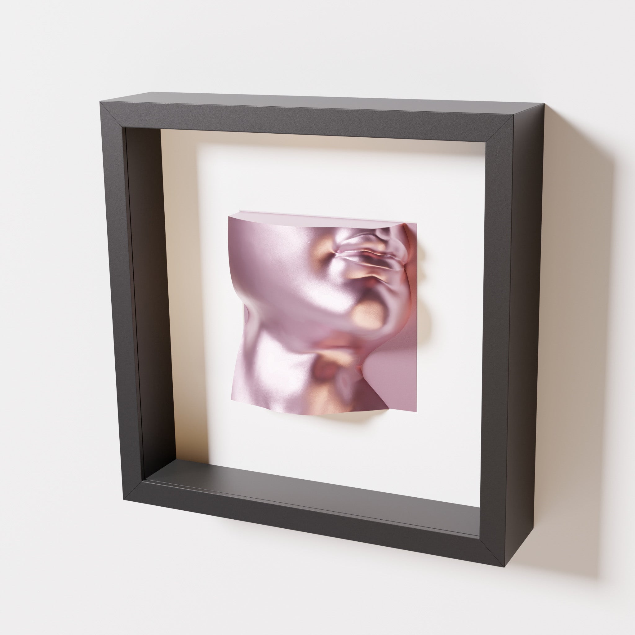 A close-up of a black shadowbox frame containing a metallic rose sculpture of 'David's Lip,' highlighting the detailed lips, chin, and reflective pink finish inspired by Michelangelo's David.