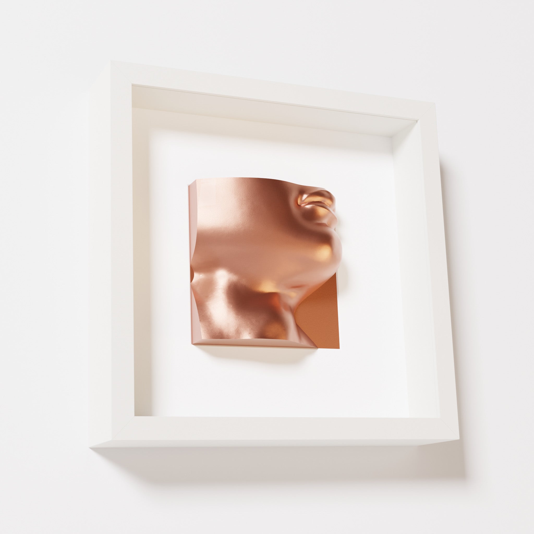 A close-up of a white shadowbox frame containing a chrome copper sculpture of 'David's Lip,' highlighting the detailed lips, chin, and reflective copper finish inspired by Michelangelo's David.