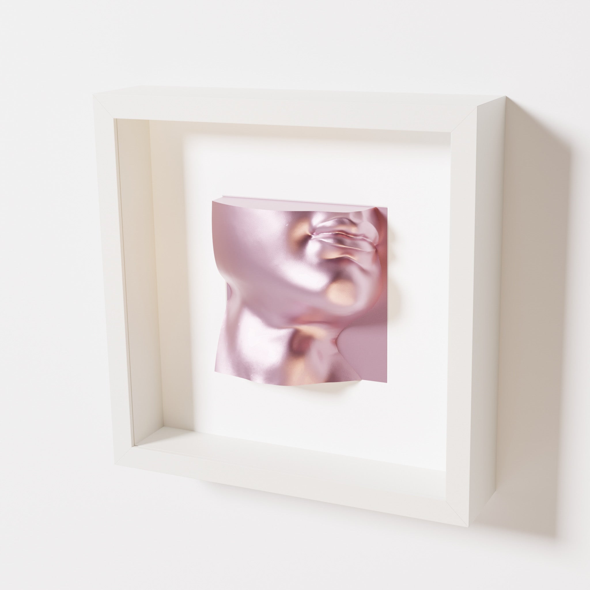 A close-up of a white shadowbox frame containing a metallic rose sculpture of 'David's Lip,' highlighting the detailed lips, chin, and reflective pink finish inspired by Michelangelo's David.