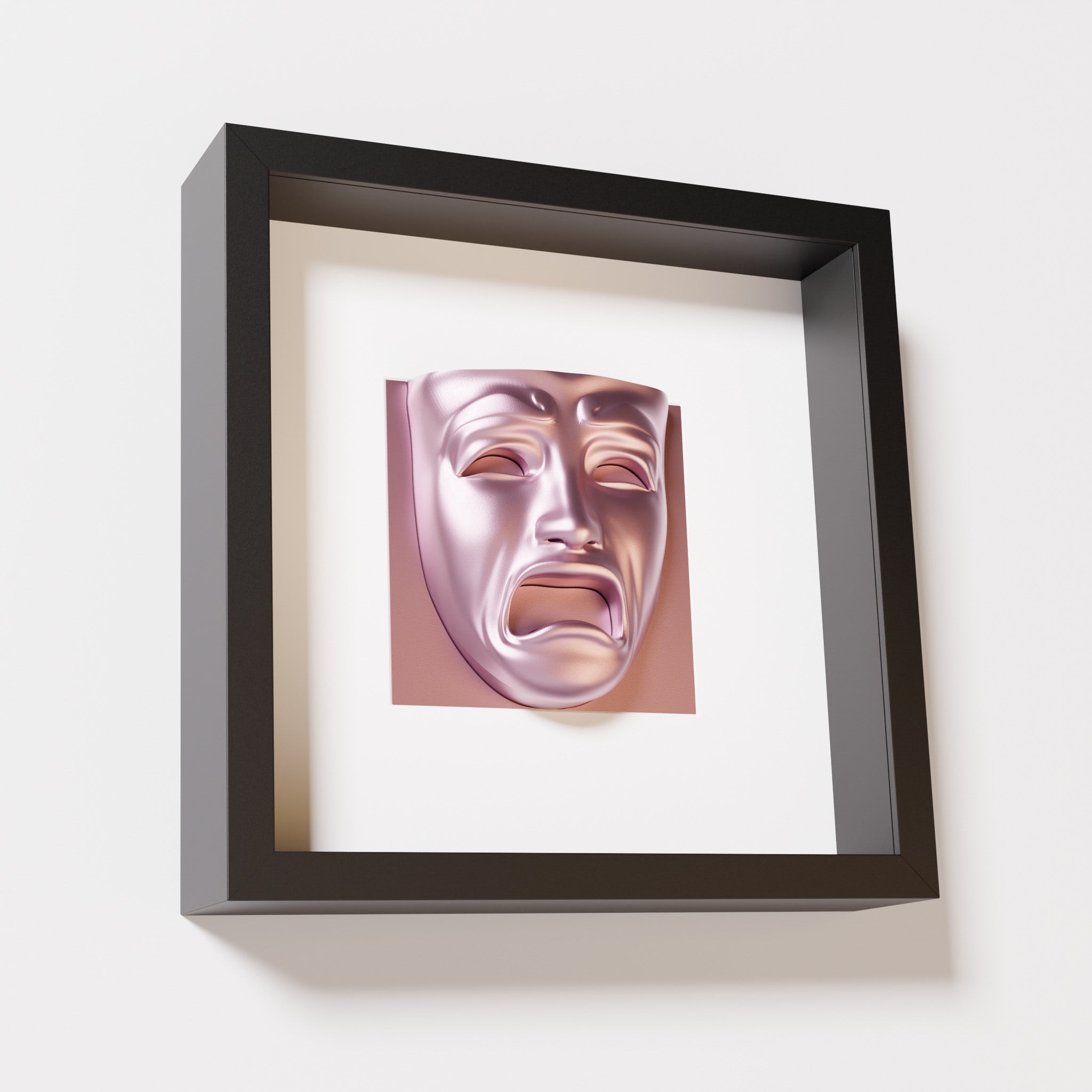 A close-up of a black shadowbox frame containing a metallic rose sculpture of 'Despair,' showcasing the expressive mask with furrowed brows, hollow eyes, and an open mouth.