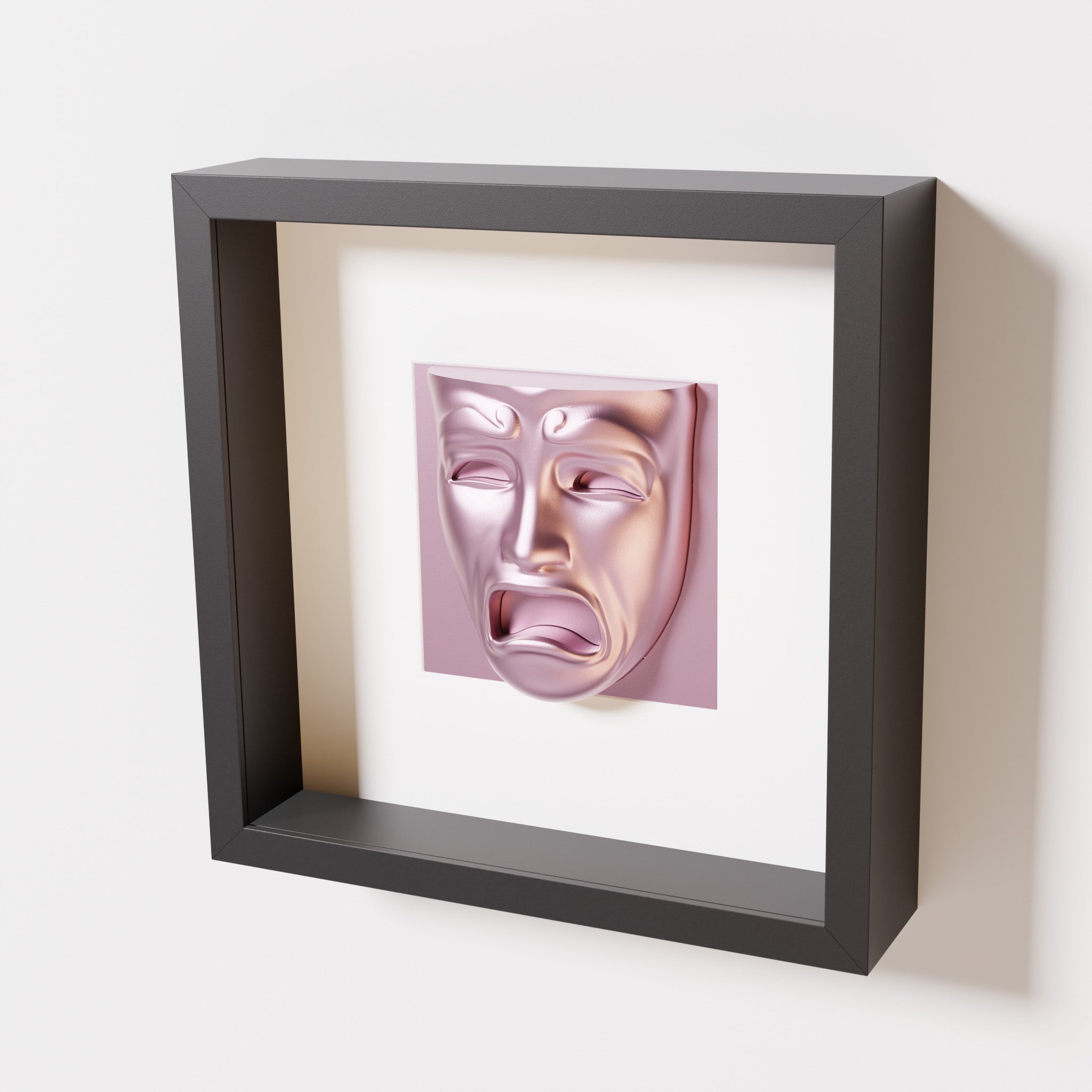 A close-up of a black shadowbox frame containing a metallic rose sculpture of 'Despair,' showcasing the expressive mask with furrowed brows, hollow eyes, and an open mouth.