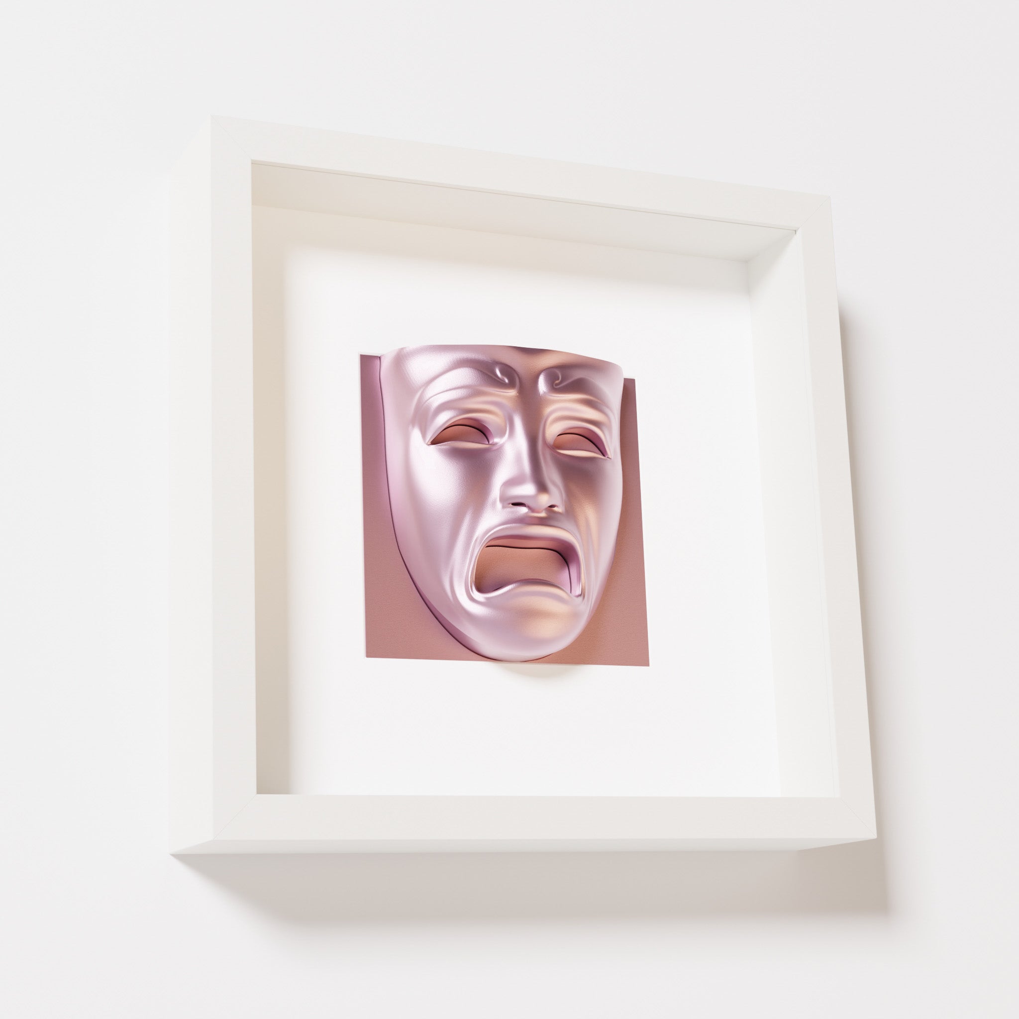 A close-up of a white shadowbox frame containing a metallic rose sculpture of 'Despair,' showcasing the expressive mask with furrowed brows, hollow eyes, and an open mouth.