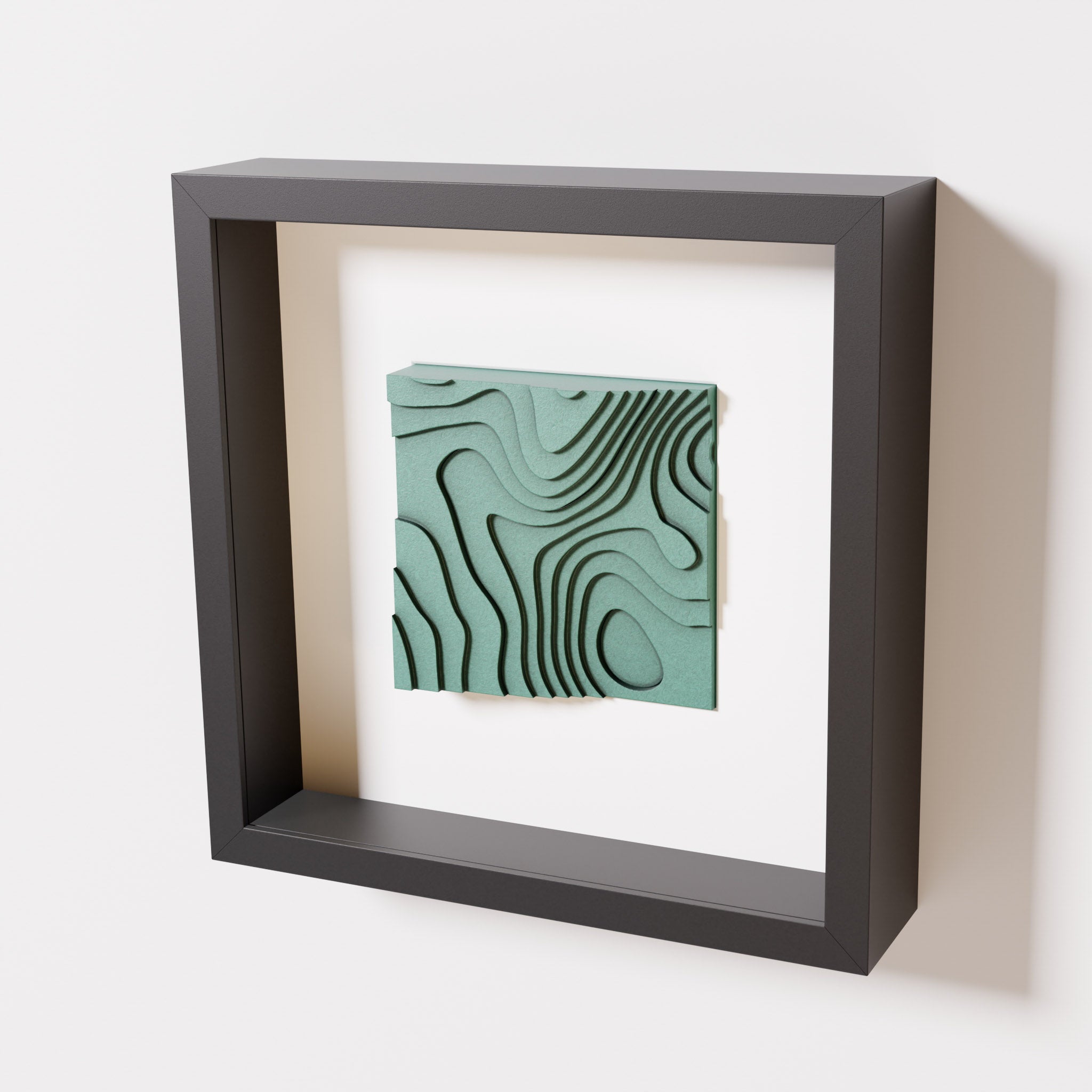 A close-up of a black shadowbox frame containing an old patina artwork depicting flowing contour lines inspired by geographic elevation levels, showcasing intricate geometric details with a textured green finish.