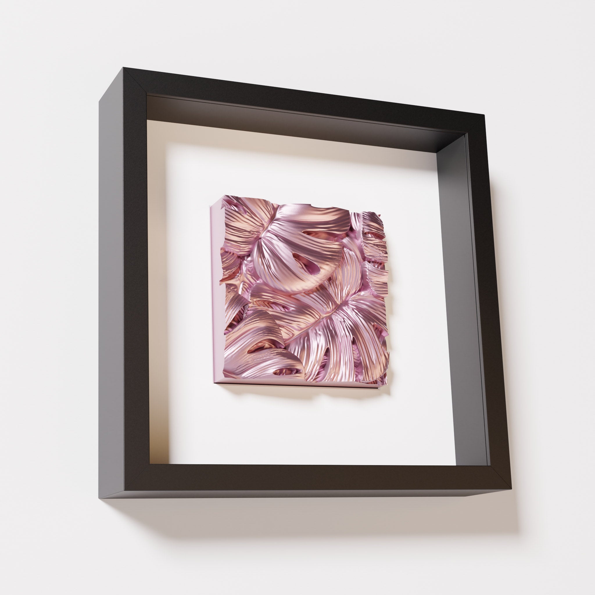 A close-up of a black shadowbox frame containing a metallic rose artwork featuring layered Monstera leaves, showcasing reflective pink highlights and intricate overlapping details.