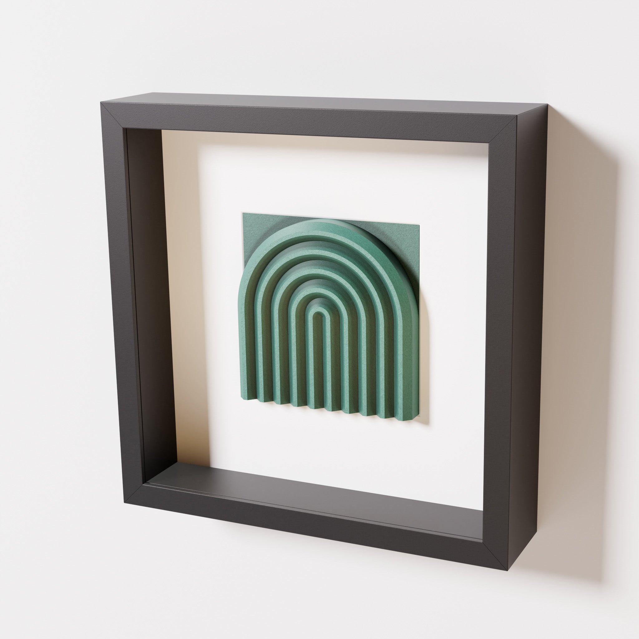 A close-up of a black shadowbox frame containing an old patina artwork featuring the gentle arc of a rainbow design, showcasing its textured green finish and detailed layering.