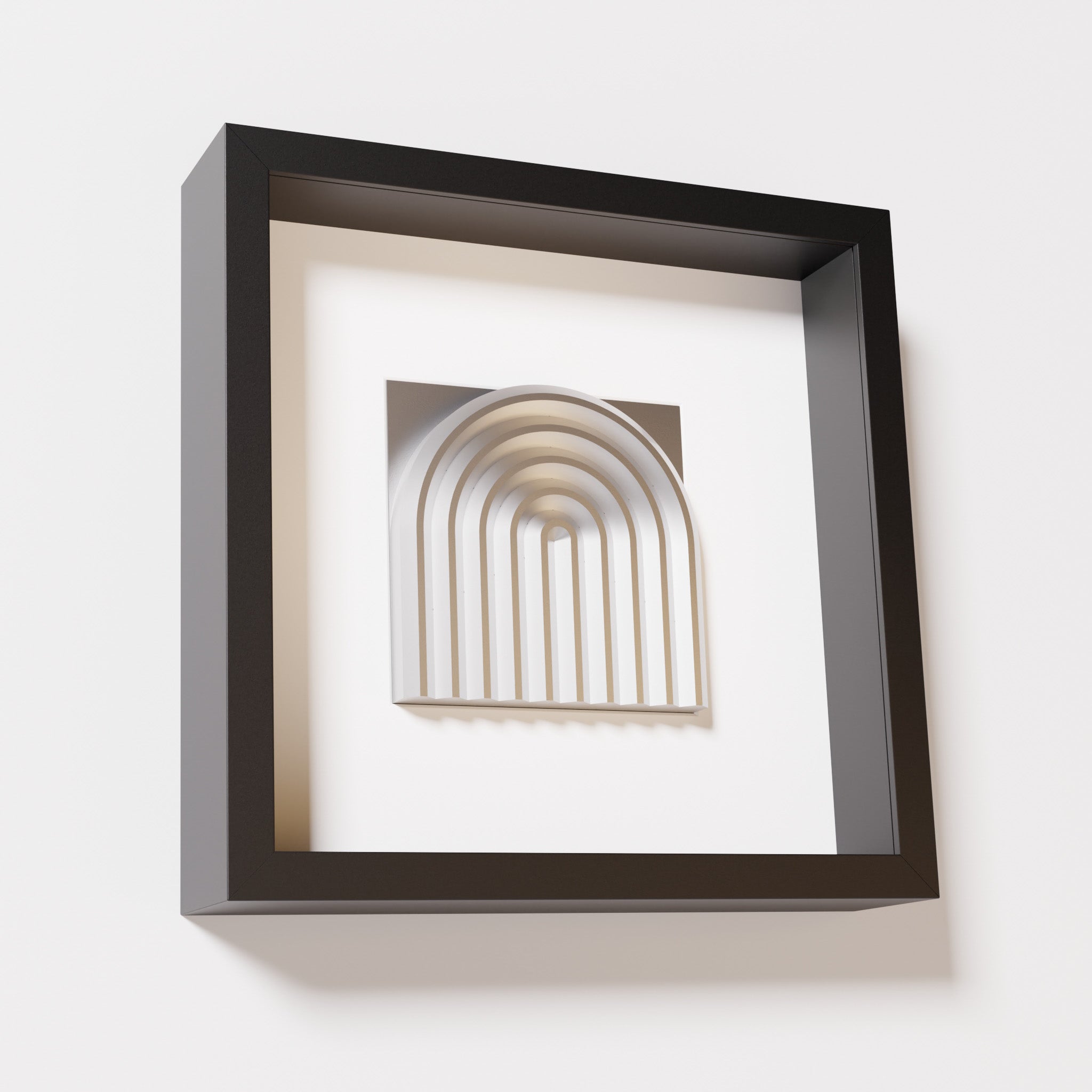 A close-up of a black shadowbox frame containing a chrome silver artwork featuring the gentle arc of a rainbow design, showcasing its reflective silver highlights and elegant curves.