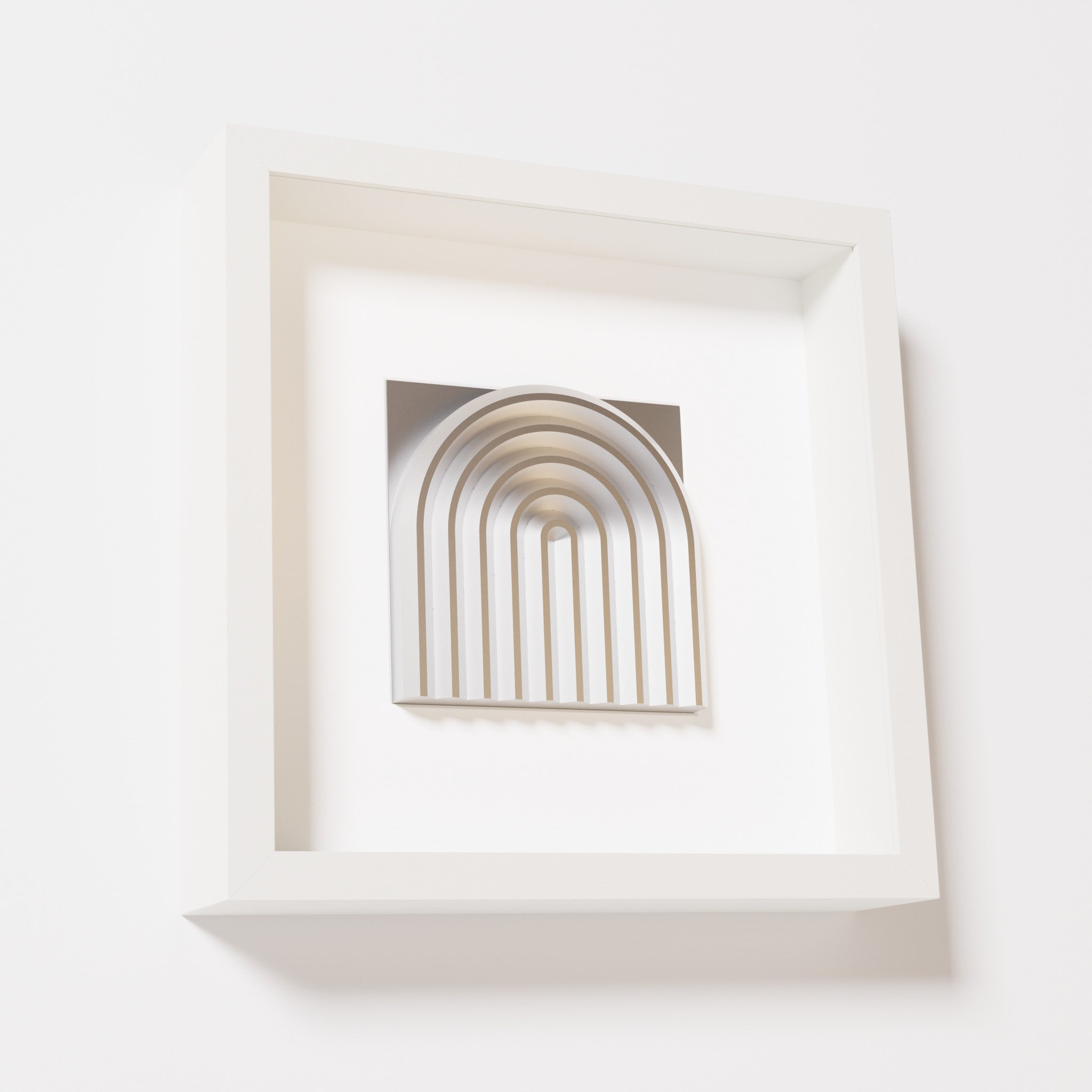 A close-up of a white shadowbox frame containing a chrome silver artwork featuring the gentle arc of a rainbow design, showcasing its reflective silver highlights and elegant curves.