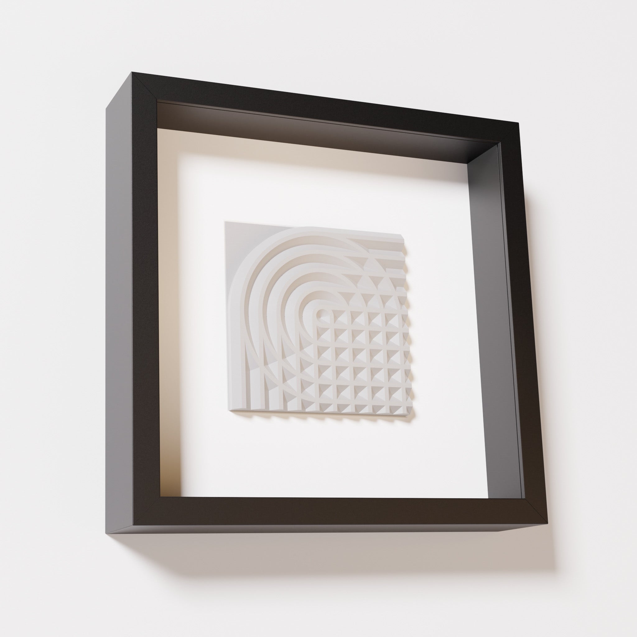 A close-up of a black shadowbox frame containing a marble white artwork featuring the elegant arcs and geometric grid of 'Rainbow II,' showcasing a smooth and refined texture.