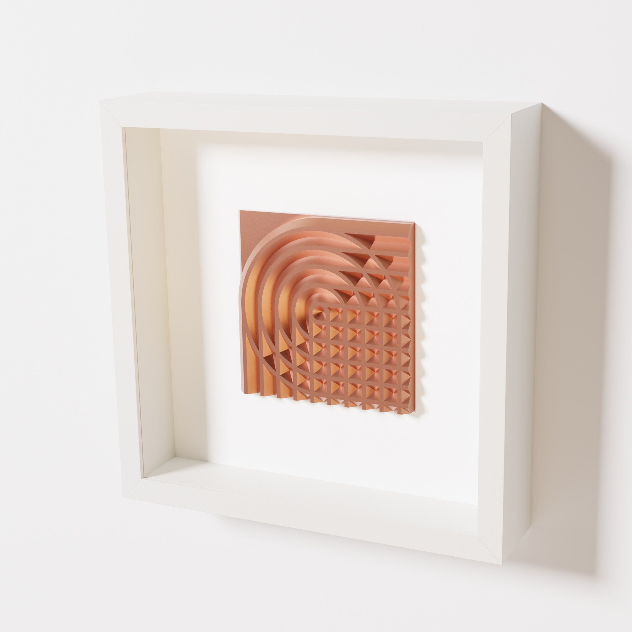 A close-up of a white shadowbox frame containing a chrome copper artwork featuring the elegant arcs and geometric grid of 'Rainbow II,' showcasing reflective copper highlights.