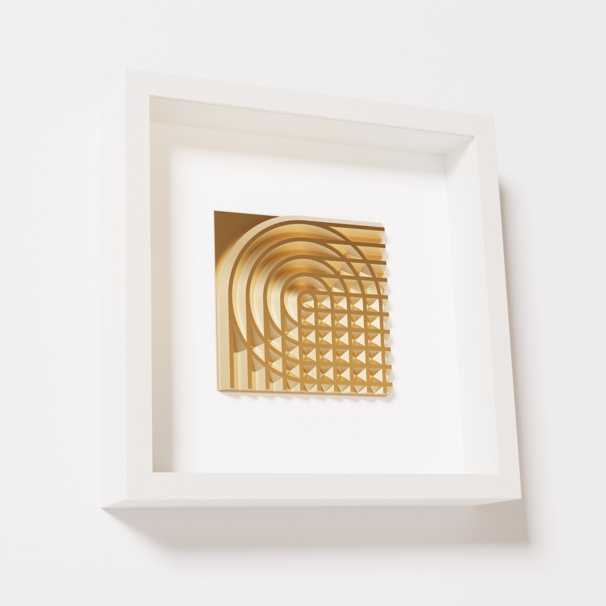 A close-up of a white shadowbox frame containing a chrome gold artwork featuring the elegant arcs and geometric grid of 'Rainbow II,' showcasing reflective golden highlights.