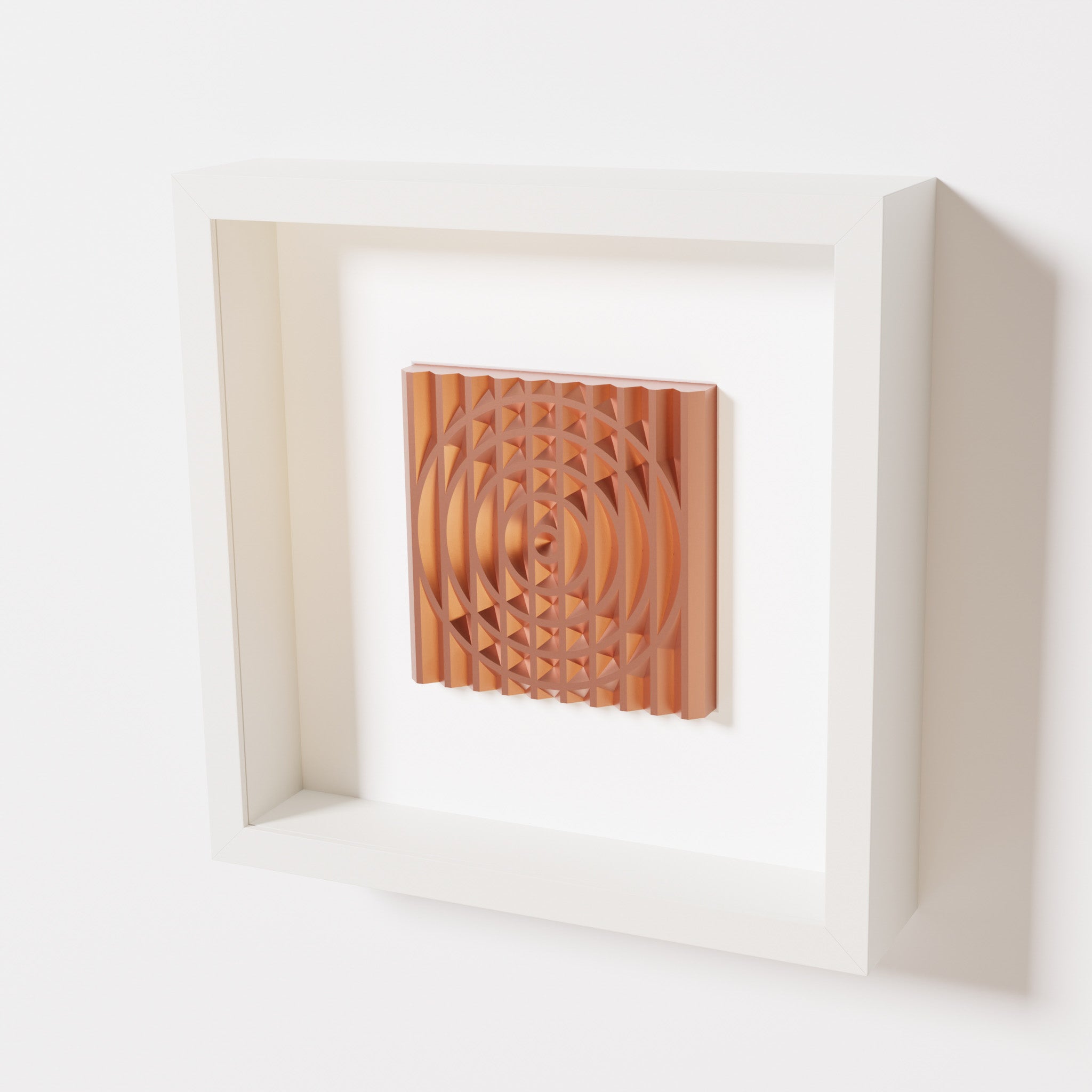 A close-up of a white shadowbox frame containing a chrome copper artwork featuring the elegant arcs and geometric grid of 'Rainbow III,' showcasing reflective copper highlights.