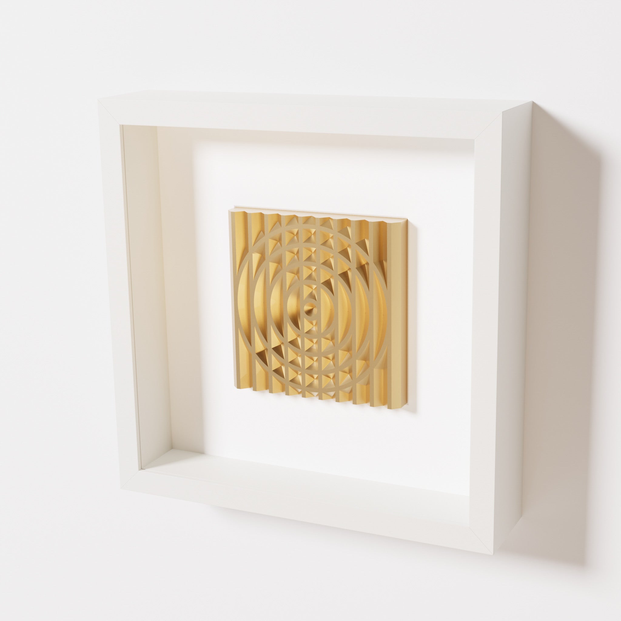 A close-up of a white shadowbox frame containing a chrome gold artwork featuring the elegant arcs and geometric grid of 'Rainbow III,' showcasing reflective golden highlights.