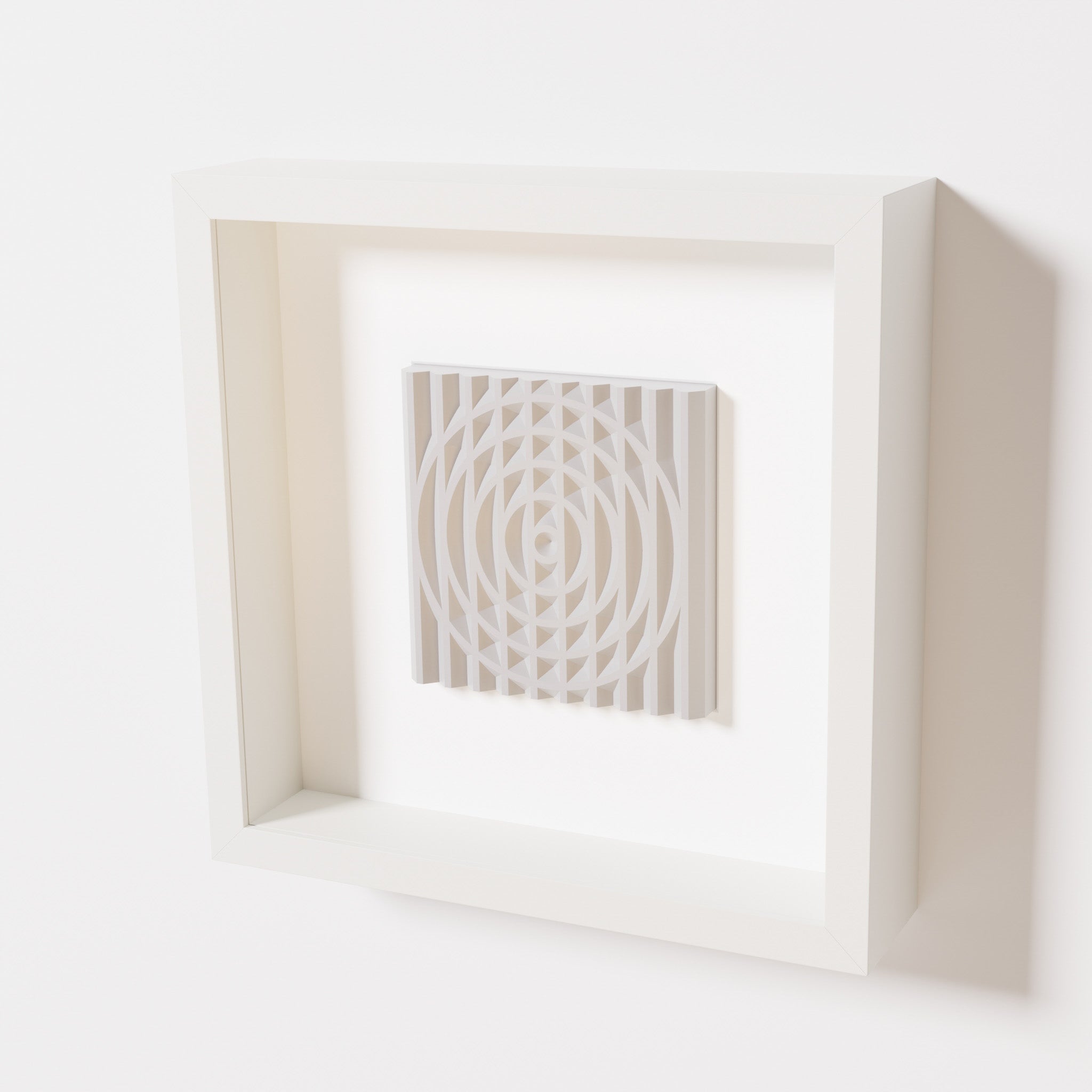 A close-up of a white shadowbox frame containing a marble white artwork featuring the elegant arcs and geometric grid of 'Rainbow III,' emphasizing its smooth texture and refined design.