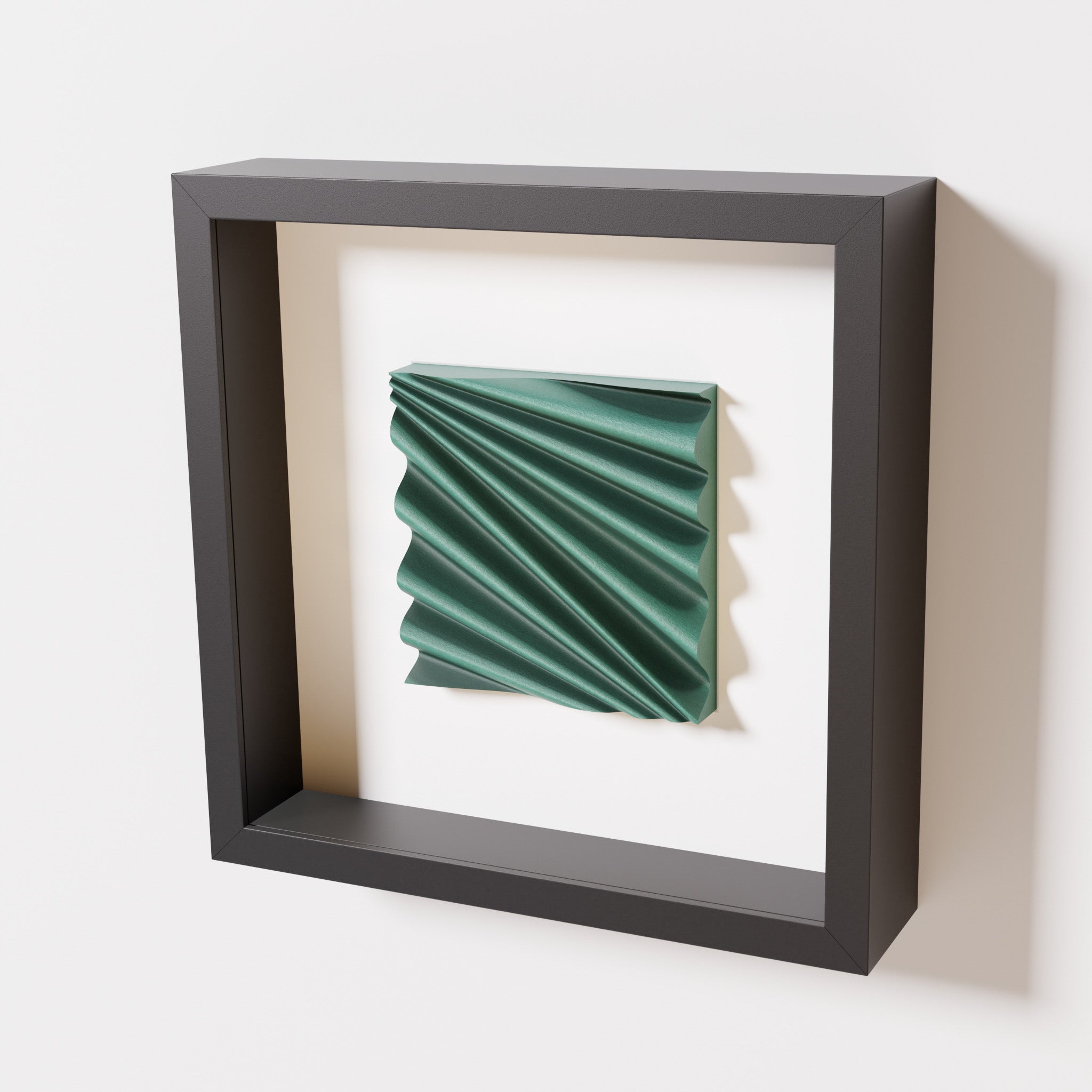 A close-up of a black shadowbox frame containing an old patina artwork featuring the rhythmic crests and troughs of 'Wave,' showcasing a textured green finish and intricate detail.