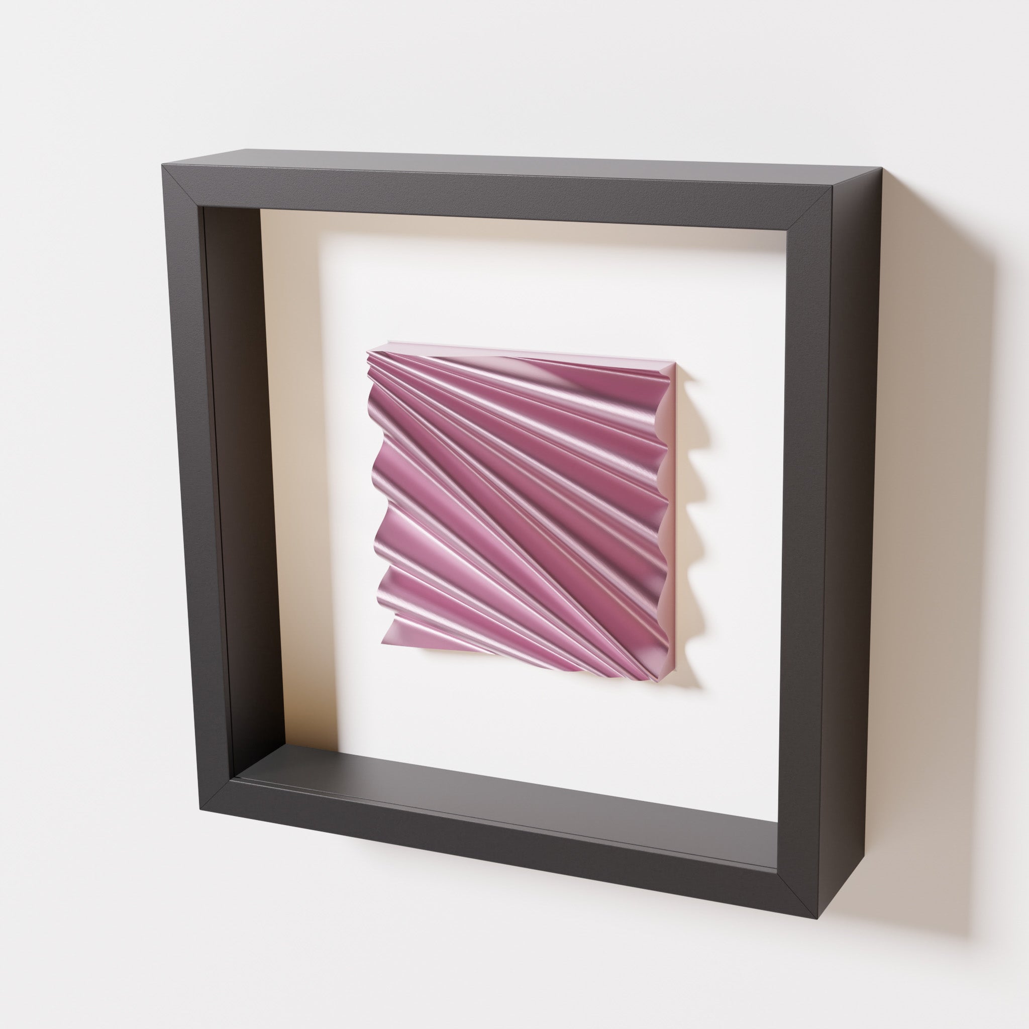 A close-up of a black shadowbox frame containing a metallic rose artwork featuring the rhythmic crests and troughs of 'Wave,' showcasing reflective pink highlights.