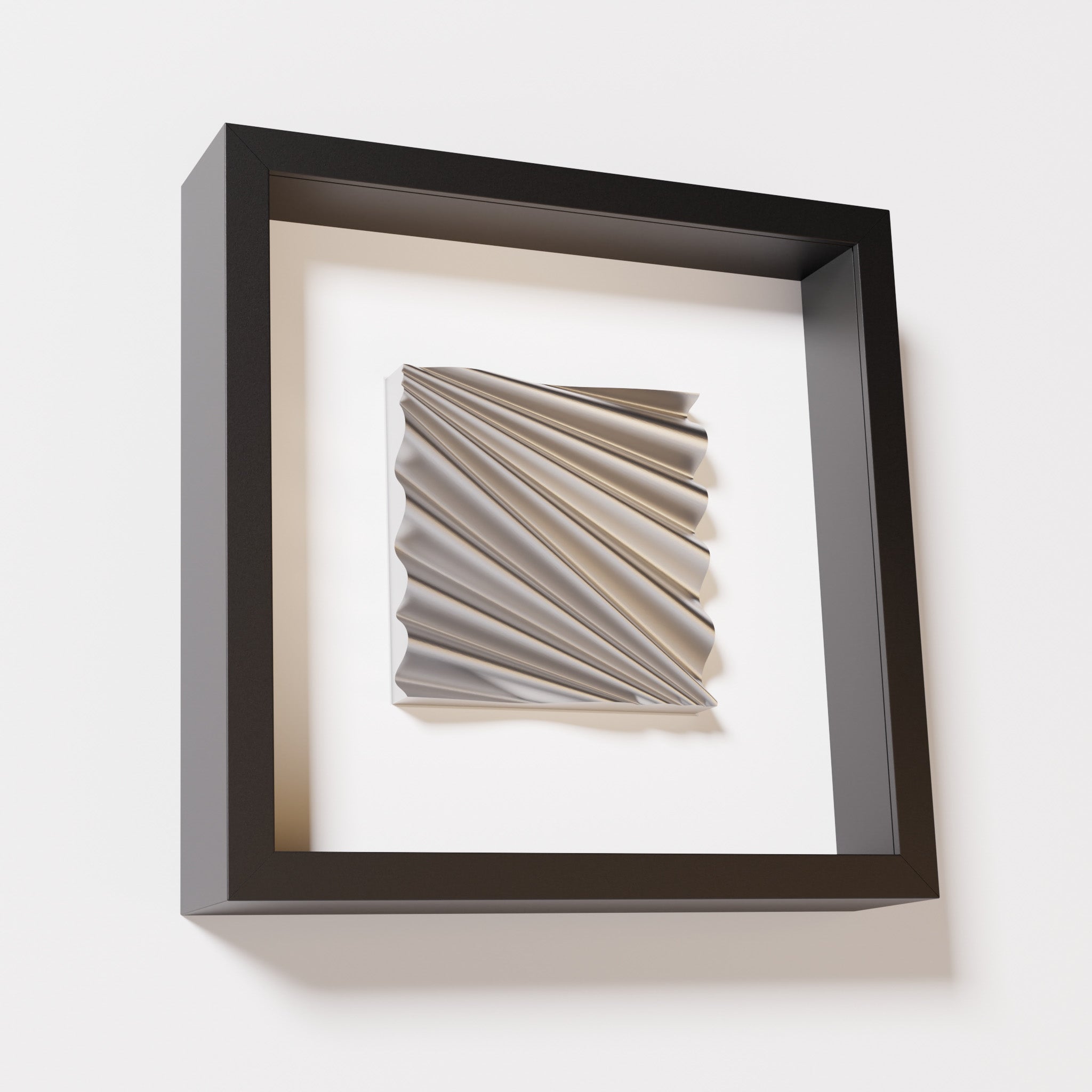 A close-up of a black shadowbox frame containing a chrome silver artwork featuring the rhythmic crests and troughs of 'Wave,' showcasing reflective silver highlights.