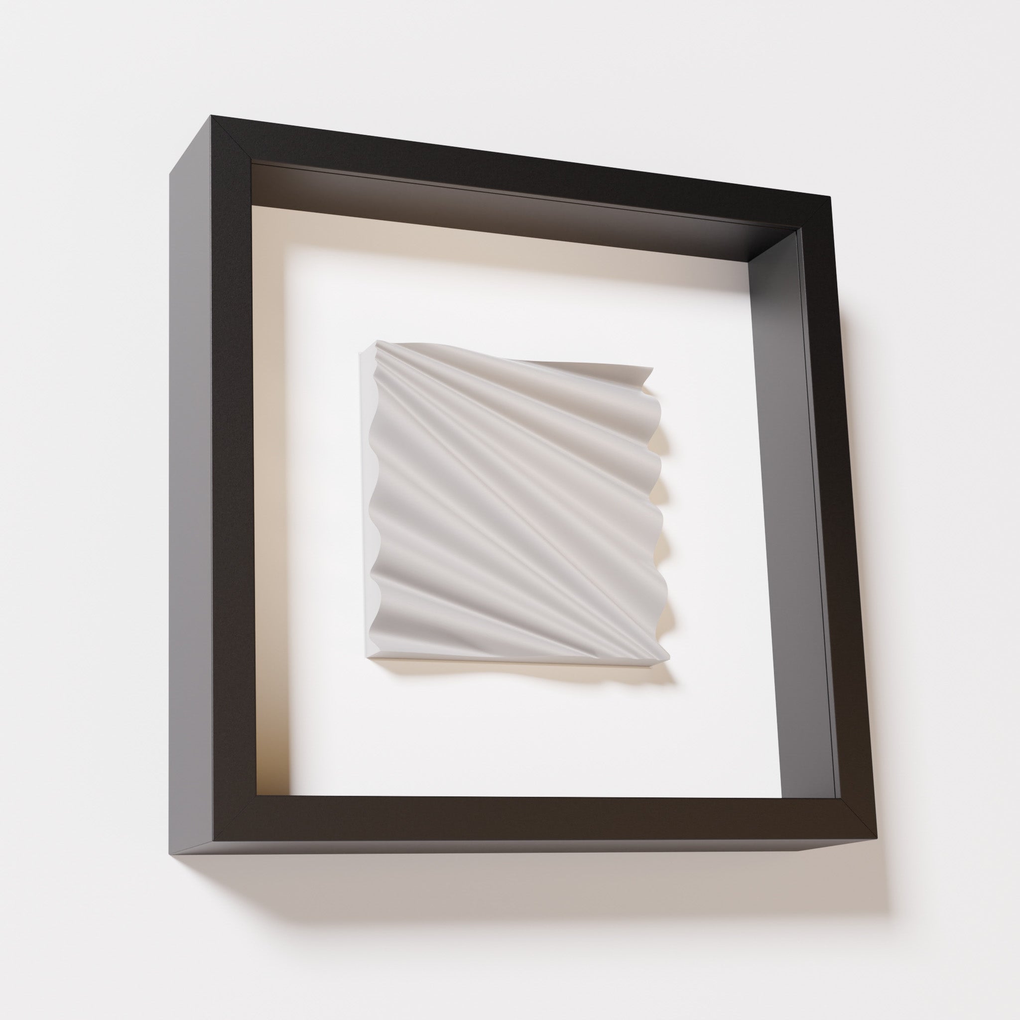 A close-up of a black shadowbox frame containing a marble white artwork featuring the rhythmic crests and troughs of 'Wave,' emphasizing its smooth texture and dynamic design.