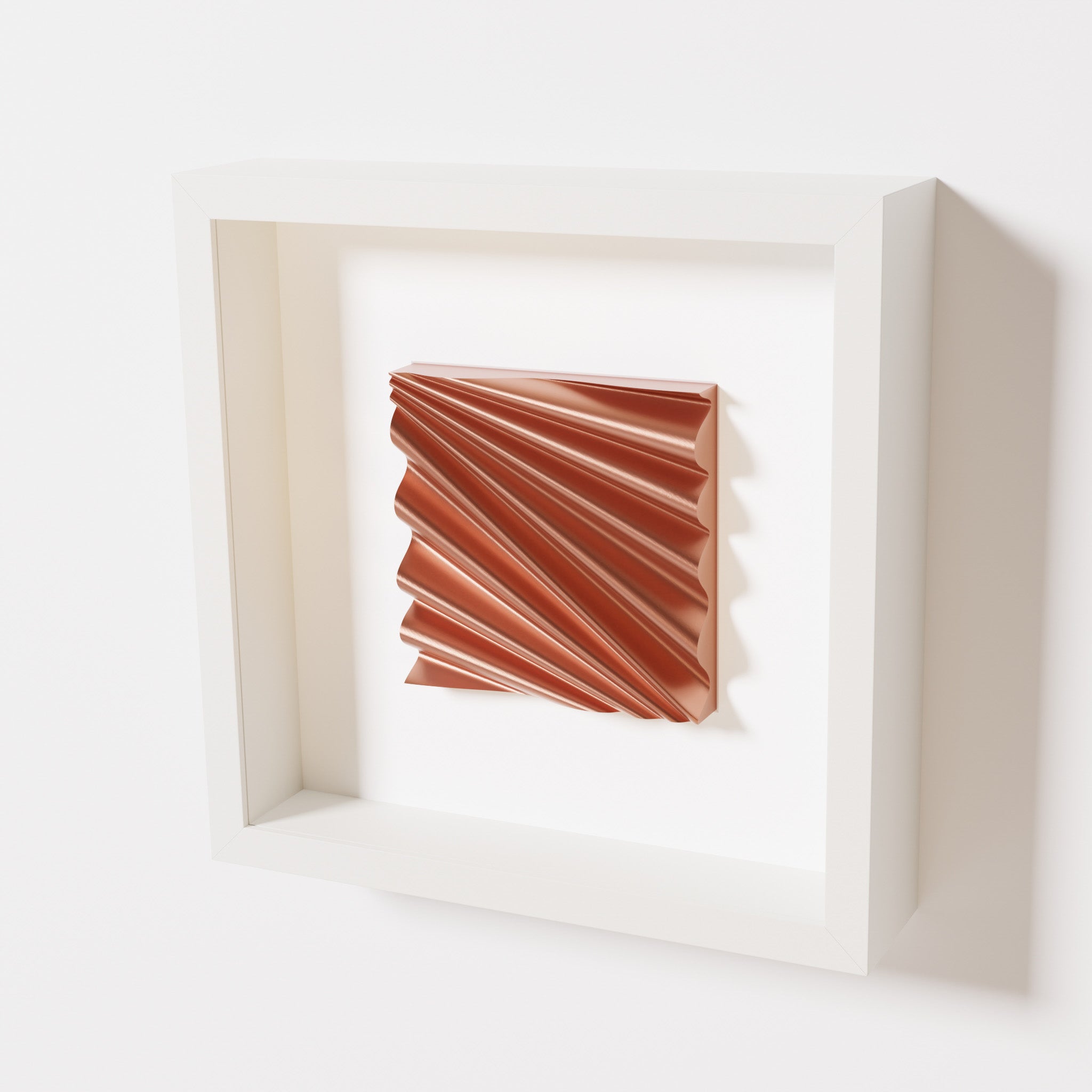 A close-up of a white shadowbox frame containing a chrome copper artwork featuring the rhythmic crests and troughs of 'Wave,' showcasing reflective copper highlights.