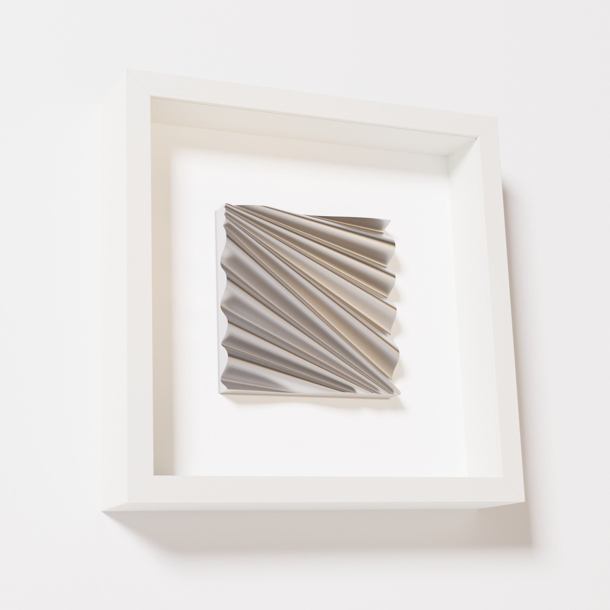 A close-up of a white shadowbox frame containing a chrome silver artwork featuring the rhythmic crests and troughs of 'Wave,' showcasing reflective silver highlights.