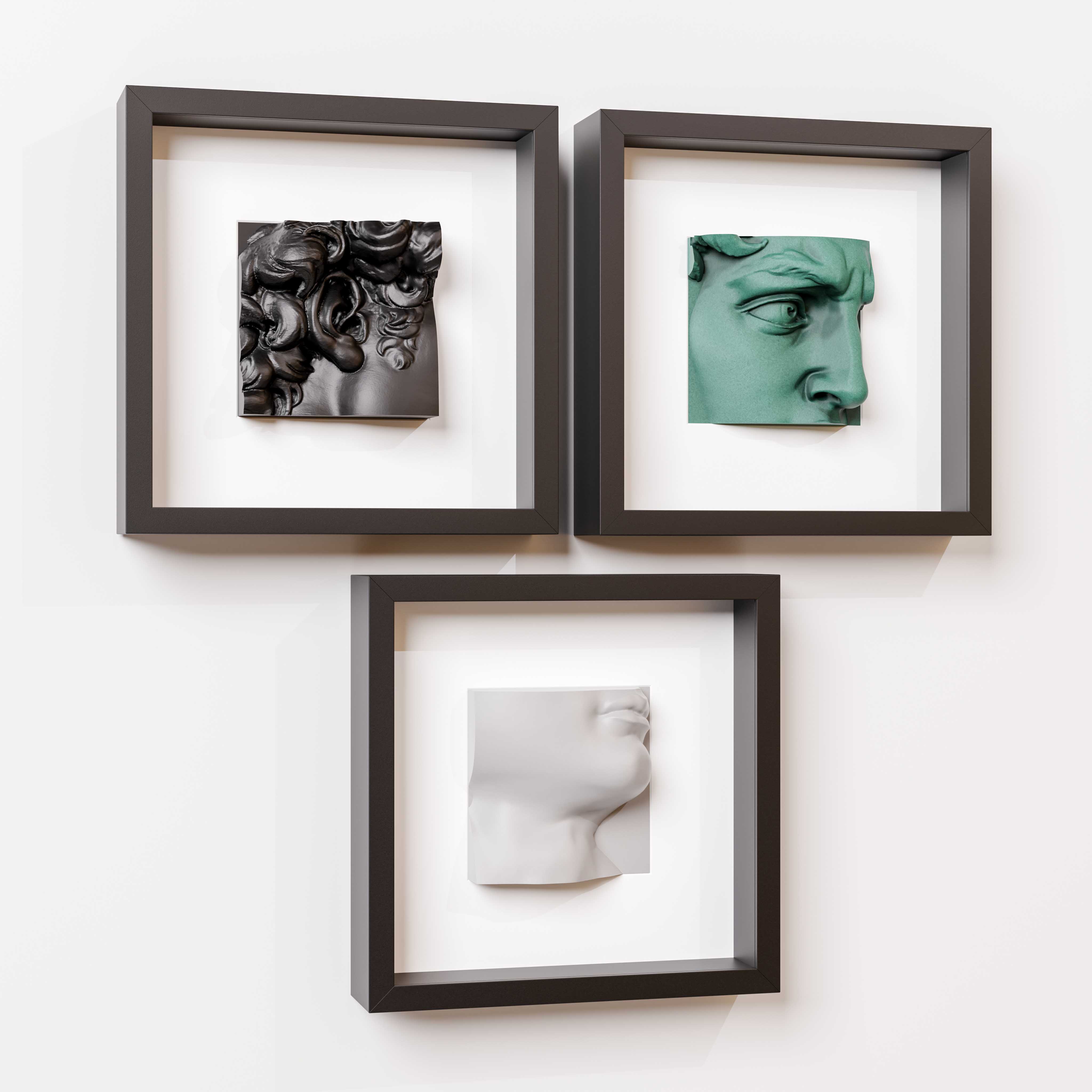 A minimalist arrangement of three black shadowbox frames, each showcasing a unique 3D sculpture: a black intricate Baroque-inspired design, a green classical eye detail, and a white modern profile of a face. Mounted on a clean white wall, this art display highlights a blend of textures, colors, and artistic styles, perfect for contemporary interior decor.